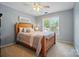 Serene bedroom with a wooden bed frame, neutral bedding, and a soft gray color scheme at 10223 Willingham Rd, Huntersville, NC 28078