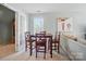 Cozy dining area with a wooden table and chairs, adjacent to a living space, lit by natural light at 10223 Willingham Rd, Huntersville, NC 28078