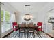 Elegant dining room with stylish lighting, a large window, and seating for six at 10223 Willingham Rd, Huntersville, NC 28078