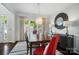 Elegant dining room with a large window, stylish lighting, and seating for six at 10223 Willingham Rd, Huntersville, NC 28078