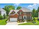Charming brick home featuring manicured landscaping, a two-car garage, and classic architectural details at 10223 Willingham Rd, Huntersville, NC 28078