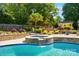 Inviting hot tub with stone surround waterfall in a beautifully landscaped backyard at 10223 Willingham Rd, Huntersville, NC 28078