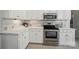 Modern kitchen showcasing stainless steel appliances, tile backsplash, and bright cabinetry at 10223 Willingham Rd, Huntersville, NC 28078