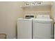 Functional laundry room with a modern washer and dryer, a shelf, and organized laundry accessories at 10223 Willingham Rd, Huntersville, NC 28078