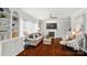 Spacious living room featuring a fireplace, hardwood floors, and large windows at 10223 Willingham Rd, Huntersville, NC 28078