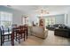 Spacious living room with a dining area, neutral-colored sofas, and natural light from multiple windows at 10223 Willingham Rd, Huntersville, NC 28078