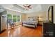 Bright main bedroom with a tray ceiling, large window and bedside tables at 10223 Willingham Rd, Huntersville, NC 28078