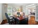 Cozy home office showcasing a large desk, and bright, natural light at 10223 Willingham Rd, Huntersville, NC 28078