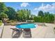 Stunning backyard pool with landscaped grounds and a cozy lounge area at 10223 Willingham Rd, Huntersville, NC 28078
