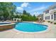 A sparkling pool features an integrated spa and serene landscaping at 10223 Willingham Rd, Huntersville, NC 28078
