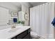 Bathroom featuring black vanity, white countertops and white tiled shower at 1148 Wessington Manor Ln, Fort Mill, SC 29715