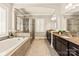 Bright bathroom featuring a soaking tub, glass shower, granite countertops, and plantation shutters for natural light at 1148 Wessington Manor Ln, Fort Mill, SC 29715