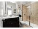 Bathroom with dark cabinets, granite countertops and a tiled shower at 1148 Wessington Manor Ln, Fort Mill, SC 29715