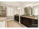 A view of the bright bathroom featuring double vanity sinks, granite countertops, and a glass enclosed shower at 1148 Wessington Manor Ln, Fort Mill, SC 29715
