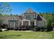Charming home with manicured lawn, covered front porch, and American flag in a lovely, residential neighborhood at 1148 Wessington Manor Ln, Fort Mill, SC 29715