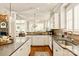 Bright eat-in kitchen features white cabinetry, stainless sink, gray countertops, and pendant lighting at 1148 Wessington Manor Ln, Fort Mill, SC 29715