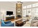 Inviting living room with a stone fireplace, large windows, and cozy furniture at 1148 Wessington Manor Ln, Fort Mill, SC 29715