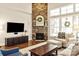Cozy living room with stone fireplace, large windows, and comfortable seating at 1148 Wessington Manor Ln, Fort Mill, SC 29715