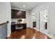 Office featuring hardwood floors, built-in cabinets, and desk with view into the bathroom at 1148 Wessington Manor Ln, Fort Mill, SC 29715