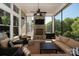 Inviting screened porch with stone fireplace, ceiling fan, comfortable seating, and outdoor TV for relaxation at 1148 Wessington Manor Ln, Fort Mill, SC 29715