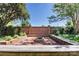 Brick-lined backyard featuring built-in benches surrounding a brick fire pit and lush landscaping at 116 N Mulberry St, Statesville, NC 28677