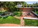 The backyard features a well-manicured lawn, patio with fire pit, garden area and lovely coy pond at 116 N Mulberry St, Statesville, NC 28677