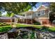 The backyard features a covered porch, lush lawn and garden area, as well as a lovely coy pond at 116 N Mulberry St, Statesville, NC 28677