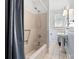 Bathroom with a shower-tub combo and a pedestal sink illuminated by natural light at 116 N Mulberry St, Statesville, NC 28677