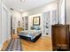 Bedroom featuring hardwood floors, built-in shelves, and a decorative rug at 116 N Mulberry St, Statesville, NC 28677