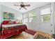 Bedroom with a ceiling fan, wood floors, and bright windows overlooking the outdoors at 116 N Mulberry St, Statesville, NC 28677