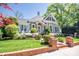 Charming historic home with mature landscaping, brick entry and walkway, and inviting front porch at 116 N Mulberry St, Statesville, NC 28677