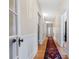 Long hallway with hardwood floors, white wainscoting, and access to multiple rooms at 116 N Mulberry St, Statesville, NC 28677