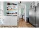 Convenient laundry area with modern washer/dryer units and ample storage shelving at 116 N Mulberry St, Statesville, NC 28677