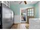 Practical mud room with stainless steel refrigerator and access to an outdoor seating area at 116 N Mulberry St, Statesville, NC 28677