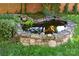 Lush backyard pond with stone edging, waterfall, and greenery at 116 N Mulberry St, Statesville, NC 28677