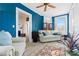 Bright sun room featuring tiled floors, blue walls, and plenty of windows for natural light at 116 N Mulberry St, Statesville, NC 28677