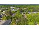 Aerial view of a residential neighborhood surrounded by lush greenery and mature trees at 12536 Hennigan Place Ln, Charlotte, NC 28214