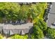 Aerial view of the home, showcasing the roof, surrounding trees, and neighboring properties at 12536 Hennigan Place Ln, Charlotte, NC 28214