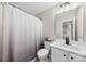 Clean bathroom with shower, toilet, and single sink vanity with black hardware and fixtures at 12536 Hennigan Place Ln, Charlotte, NC 28214
