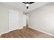 Bedroom featuring hardwood floors and white walls with two white doors and updated electrical outlets at 12536 Hennigan Place Ln, Charlotte, NC 28214