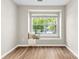 Bright bedroom with hardwood floors, a window seat and large window showing exterior greenery at 12536 Hennigan Place Ln, Charlotte, NC 28214