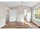 Bright bedroom showcasing wood floors, natural light, neutral walls, and two closets at 12536 Hennigan Place Ln, Charlotte, NC 28214