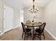 Cozy dining area with chandelier, wooden table, and chairs, illuminated by natural light at 12536 Hennigan Place Ln, Charlotte, NC 28214