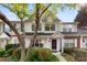 Charming townhome featuring a purple door, well-maintained landscaping, and a welcoming front porch at 12536 Hennigan Place Ln, Charlotte, NC 28214