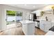 Modern kitchen featuring white cabinets, quartz countertops, stainless steel appliances, and backyard access at 12536 Hennigan Place Ln, Charlotte, NC 28214