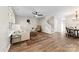 Bright living room featuring wood flooring, staircase, ceiling fan, and plenty of natural light at 12536 Hennigan Place Ln, Charlotte, NC 28214