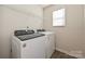 Laundry room features a Whirlpool washer and dryer, a small window, and wire shelving at 1326 31St St, Conover, NC 28613