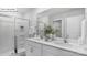 Modern bathroom with double sinks, a glass-enclosed shower, and neutral finishes at 134 Rustling Waters Dr, Mooresville, NC 28117