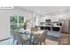 Open-concept kitchen and dining area with modern appliances, white cabinetry, and seating at the kitchen island at 134 Rustling Waters Dr, Mooresville, NC 28117