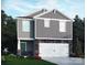 Charming two-story home boasts stone accents, gray siding, and a two-car garage, all in a well-manicured lawn at 1342 31St St, Conover, NC 28613